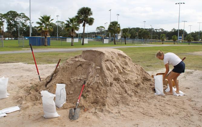 Melissa Hall filled up sandbags in advance of Hurricane Milton. She said she has lived on Amelia Island since 1993, and her home was flooded during recent heavy rains, and she wants to be prepared for Milton. Photo by Julia Roberts/News-Leader