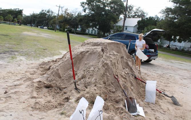 Melissa Hall filled up sandbags in advance of Hurricane Milton. She said she has lived on Amelia Island since 1993, and her home was flooded during recent heavy rains, and she wants to be prepared for Milton. Photo by Julia Roberts/News-Leader