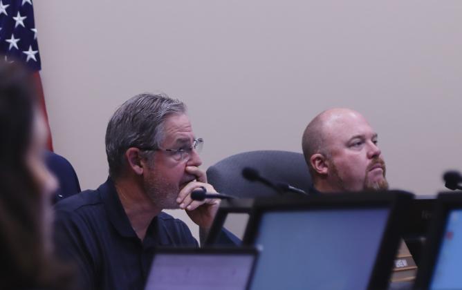 Commissioners A.M. "Hupp" Huppmann and Klynt Farmer listen to Emergency Management Director Tim Cooper on Monday at the Board of County Commissioners emergency meeting. Photo by Ashley Chandler/News-Leader
