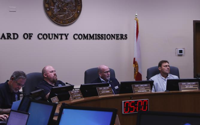 From left, commissioners A.M. "Hupp" Huppmann, Klynt Farmer, John Martin and Jeff Gray listen to Emergency Management Director Tim Cooper on Monday at the Board of County Commissioners emergency meeting Monday. Photo by Ashley Chandler/News-Leader