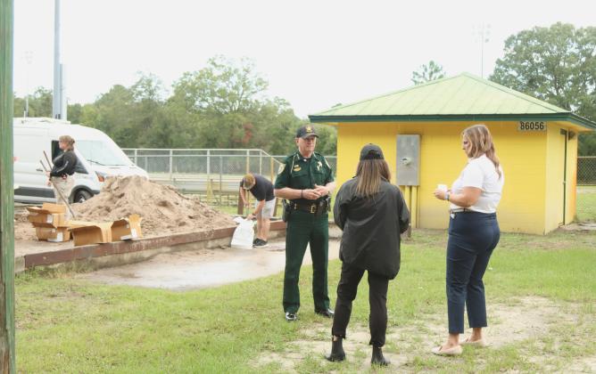 Sheriff Bill Leeper records an update in front of the sandbag operation set up Monday at Yulee Ballpark in preparation for Hurricane Milton. Photo by Ashley Chandler/News-Leader