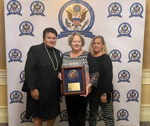 Superintendent Dr. Kathy Burns, Principal Tammy Smith, and teacher Pam Ploegert accept the National Blue Ribbon School award in Washington, D.C. Submitted photo