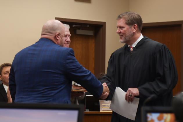 Commissioner Klynt Farmer is sworn in for another term. From left, Farmer, his father Kenny Farmer and Judge Steve Fahlgren. Photo by Ashley Chandler/News-Leader