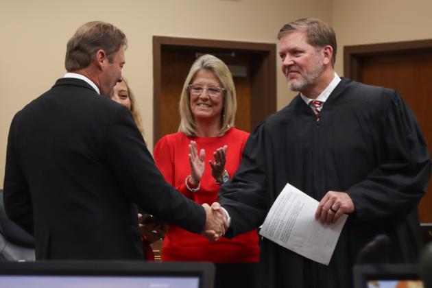 Commissioner Jeff Gray is sworn in for another term. From left, Gray, his daughter Brook, his wife Diana and Judge Steve Fahlgren. Photo by Ashley Chandler/News-Leader