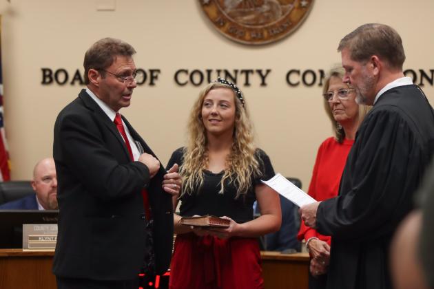 Commissioner Jeff Gray is sworn in for another term. From left, Gray, his daughter Brook, his wife Diana and Judge Steve Fahlgren. Photo by Ashley Chandler/News-Leader