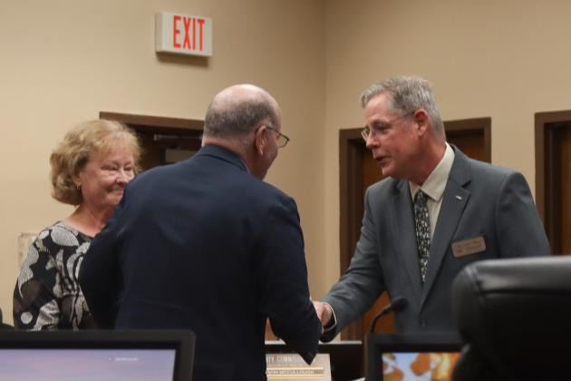Commissioner John Martin is sworn in for another term. From left, Martin, his wife Donna and Commissioner A.M. “Hupp” Huppmann. Photo by Ashley Chandler/News-Leader