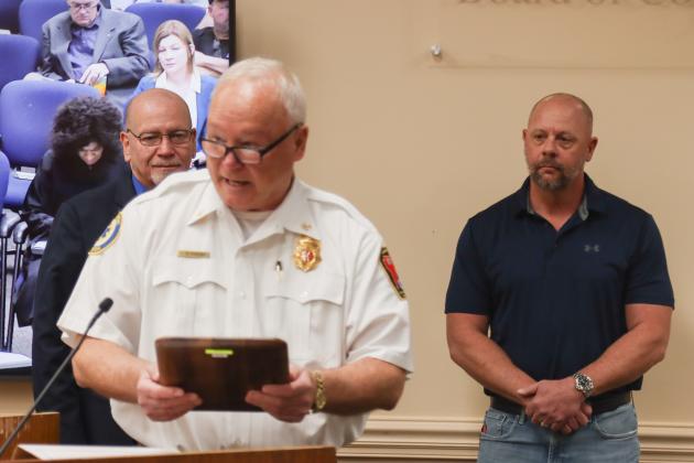 Chief Greg Roland speaks at the Dec. 18 Board of County Commissioners meeting to recognize Peter Gunnell, retiring after 31 years with Fire Rescue. Photo by Ashley Chandler/News-Leader