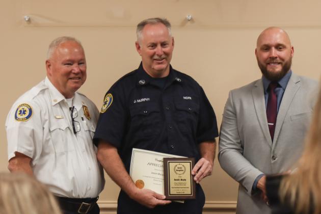 Chief Greg Roland, Jason Murphy and County Manager Taco Pope pose for a photo after Murphy was recognized Dec. 18 for 25 years with Nassau County Fire Rescue. Photo by Ashley Chandler/News-Leader