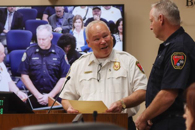 Chief Greg Roland shakes hands with Jason Murphy who was recognized Dec. 18 for 25 years with Nassau County Fire Rescue. Photo by Ashley Chandler/News-Leader