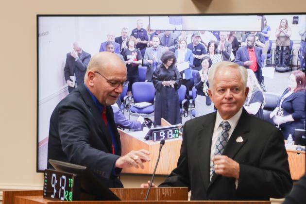 John Martin, left, presents John A. Crawford with a proclamation Dec. 18 at the Board of County Commissioners meeting, recognizing his retirement after 28 years of service as Nassau County Clerk of Courts and Comptroller. Photo by Ashley Chandler/News-Leader