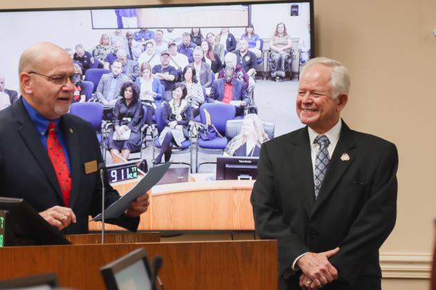 John Martin, left, presents John A. Crawford with a proclamation Dec. 18 at the Board of County Commissioners meeting, recognizing his retirement after 28 years of service as Nassau County Clerk of Courts and Comptroller. Photo by Ashley Chandler/News-Leader