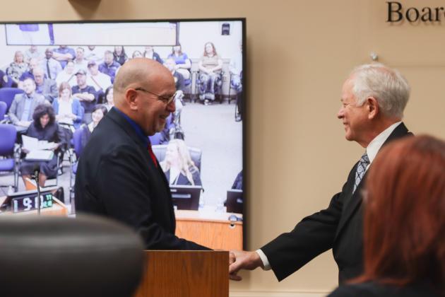 John Martin, left, presents John A. Crawford with a proclamation Dec. 18 at the Board of County Commissioners meeting, recognizing his retirement after 28 years of service as Nassau County Clerk of Courts and Comptroller. Photo by Ashley Chandler/News-Leader