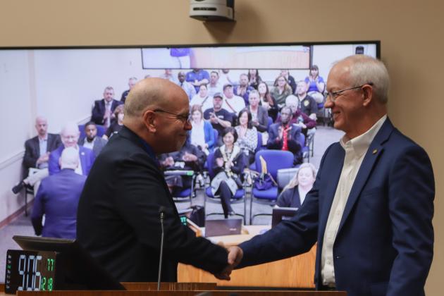 John Martin, left, presents Michael Hickox with a proclamation Dec. 18 at the Board of County Commissioners meeting, recognizing his retirement after 12 years of service as Nassau County Property Appraiser after 12 years of service. Photo by Ashley Chandler/News-Leader