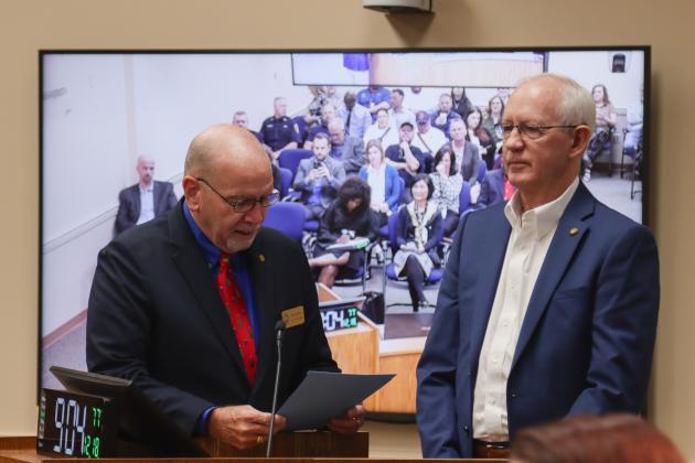 John Martin, left, presents Michael Hickox with a proclamation Dec. 18 at the Board of County Commissioners meeting, recognizing his retirement after 12 years of service as Nassau County Property Appraiser after 12 years of service. Photo by Ashley Chandler/News-Leader