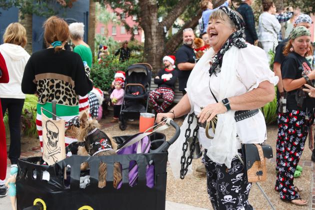 The Lady Judith, Judie Mackie, is pictured dressed in her pirate PJs with her furry friend at the Black Friday Pajama Party. Several members of the Fernandina Pirates Club took part in the pajama contest Friday. Photo by Ashley Chandler/News-Leader
