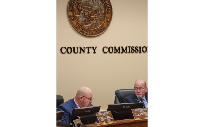 Commissioner Klynt Farmer, left, speaks Monday at Board of County Commissioners meeting as John Martin listens. Photo by Ashley Chandler/News-Leader