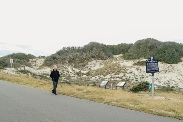Don Rung passes NaNa Dune on his morning walk Tuesday. Rung said he walks several miles a day, often walking the sands of American Beach and passing historic places like NaNa Dune and Evan’s Rendezvous. He said he hopes American Beach receives the National Historic Landmark designation. Photo by Ashley Chandler/News-Leader