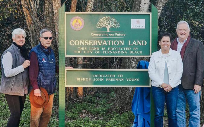 From left, Fernandina Beach Conservation and Environmental Manager Kathy Russell, North Florida Land Trust President and CEO Allison DeFoor, City Commissioner Joyce Tuten and Chief Operating Officer of the Episcopal Diocese of Florida Keith Daw pose for a photo next to the newly unveiled Conservation Land sign, dedicating the city’s land on North 11th Street to Bishop John Freeman Young. Photos by Ashley Chandler/News-Leader