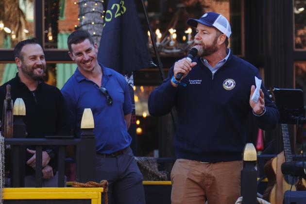 Congressman Aaron Bean, right, speaks Wednesday at Dining Down Centre, a celebration for Fernandina Beach's bicentennial. From left, OHPA Commissioner Justin Taylor and newly-elected Mayor James Antun listen. Photo by Ashley Chandler/News-Leader