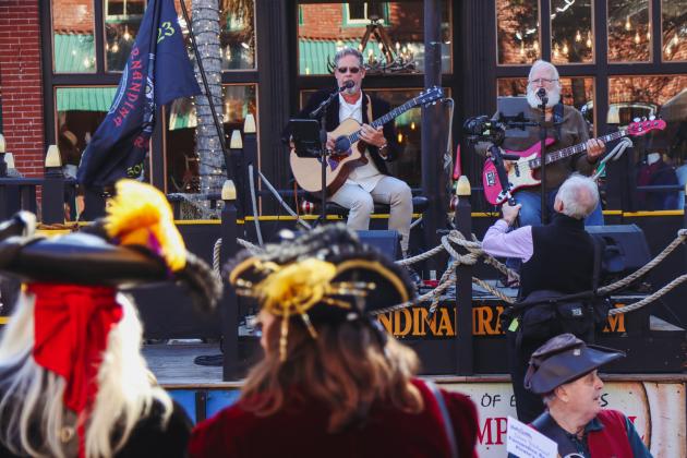Pirates listen to County Commissioner A.M “Hupp” Huppmann and Ray Hetchka, who make up Hupp and Ray, play live music at Dining Down Centre, a celebration for Fernandina's Bicentennial. Photo by Ashley Chandler/News-Leader