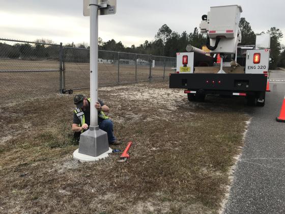 Signal Tech for Development Services Matt Hayes works on one of Nassau County's Flashing Beacons. Hayes has has since moved to a new county position as a Stormwater Drainage Inspector. Submitted photo