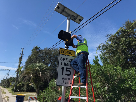 Chris Dixon installs a flashing beacon in Nassau County. Submitted photo