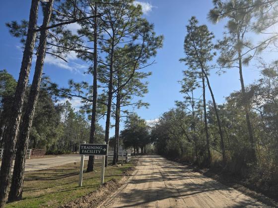A sign leads drivers down a dirt road to the Nassau County Public Safety Training Complex. Photo by Ashley Chandler/News-Leader