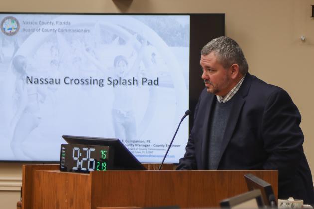 Deputy County Manager Robert Companion talks about the Nassau Crossing Park Splash Pad on Wednesday at the Board of County Commissioners meeting. The board approved an amendment to a contract with ACON Construction Co. to cover the rest of the cost of design and construction of the Splash Pad, expected to be completed by summer. Photo by Ashley Chandler/News-Leader