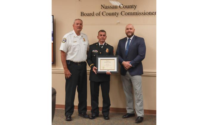 From left, Fire Chief Brady Rigdon, James Graf and County Manager Taco Pope. Graf was recognized at the Feb. 19 Board of County Commissioners meeting for his 25 years of service with Fire-Rescue. Photo by Ashley Chandler/News-Leader