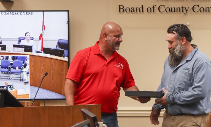 David White, right, was recognized at the Feb. 19 Board of County Commissioners meeting as the county's Employee of the Quarter. On left, Facilities Manager Tony Lombardi. Photo by Ashley Chandler/News-Leader