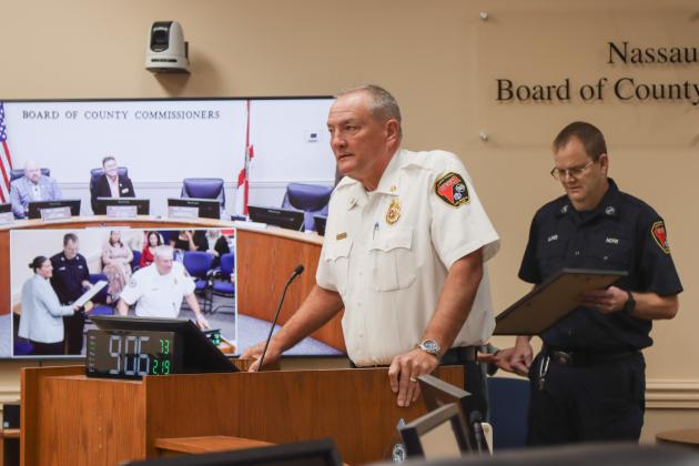 Fire Chief Brady Rigdon, left, spoke at the Feb. 19 Board of County Commissioners meeting to recognize Gregory Jones' retirement from Nassau County Fire Rescue. Photo by Ashley Chandler/News-Leader