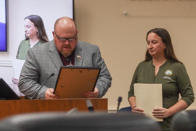 Commissioner Klynt Farmer, left, presented a proclamation to Nassau County Community Rating System Coordinator Sarah Clifton declaring March 3 through 9 as Flood Awareness Week at Monday's Board of County Commissioners meeting. Photos by Ashley Chandler/News-Leader
