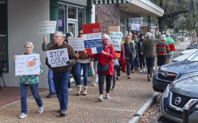Protesters were Downtown on Thursday to voice their opinion on DOGE, Social Security and Elon Musk to Congressman Aaron Bean and his staff. Photo by Ashley Chandler/News-Leader