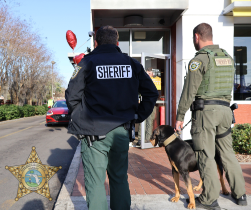 Nassau County Sheriff’s Office Deputy Daniel Jones, left, and Corrections Deputy Jacob Deal with K9 Rip at the Valentine’s Day event Hearts and Heroes at the Callahan McDonalds. The McDonald's partnered with the NCSO to raise funds for Special Olympics in conjunction with the NCSO Law Enforcement Torch Run. Submitted photo