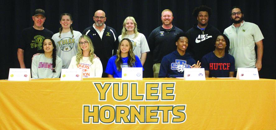 Front row from left, Kyleigh Golden and Ava Martyn (softball at Edward Waters University), Peyton Tharp (softball at South Georgia State College), Ethan Myers (football at Hutchinson Community College) and Braelyn Jones (football at St. Thomas University). They are pictured with their coaches and athletic director, back row from left, John Kent, Cristyn Gaynor, Chris Hicken, Casey Erb, Josh Burch, Jamari Rauls and Kyle Dougherty. Photo by Beth Jones/News-Leader