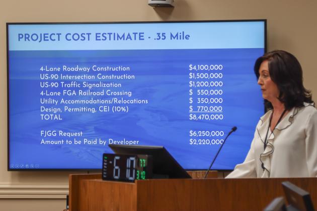 Holly Coyle, on Monday in the Commission Chambers, presents to the Board of County Commissioners a grant application for a $6.25 million grant that would fund a 4-lane roadway to connect 700 acres of industrial and commercial land. Photo by Ashley Chandler/News-Leader
