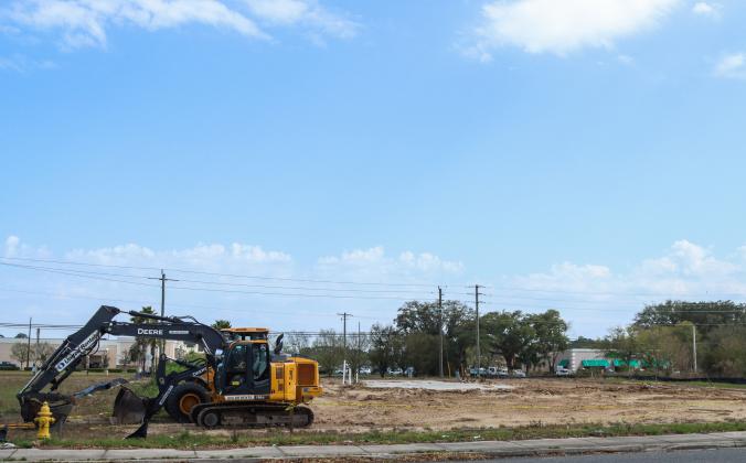 Equipment sits beside a dirt lot March 5 after the boarded up building, once meant to be a Hwy 55 Burgers, Shakes &amp; Fries, was torn down. Photo by Ashley Chandler News-Leader