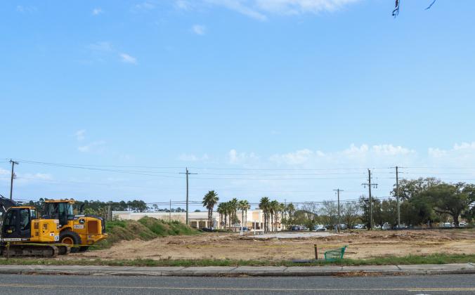 Equipment sits beside a dirt lot March 5 after the boarded up building, once meant to be a Hwy 55 Burgers, Shakes &amp; Fries, was torn down. Photo by Ashley Chandler News-Leader