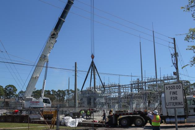 Electrical technicians and contractors work together to move a 97,000-pound transformer into the substation located at Lime and 10th streets. Photo by Ashley Chandler/News-Leader