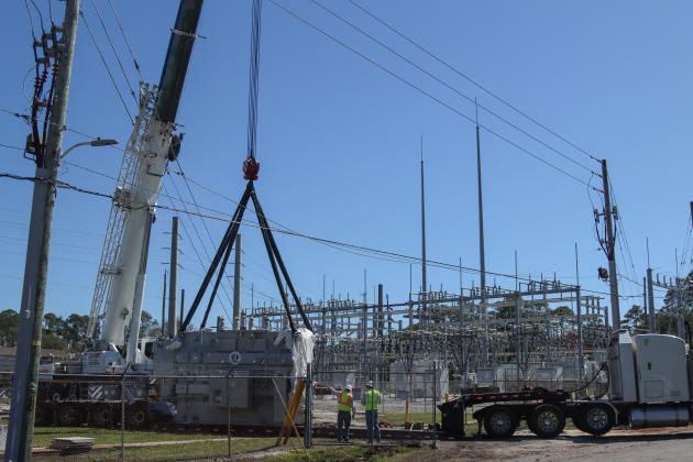 Electrical technicians and contractors work together to move a 97,000-pound transformer into the substation located at Lime and 10th streets. Photo by Ashley Chandler/News-Leader