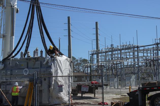 Electrical technicians and contractors work together to move a new transformer into the substation located at Lime and 10th streets. Photo by Ashley Chandler/News-Leader