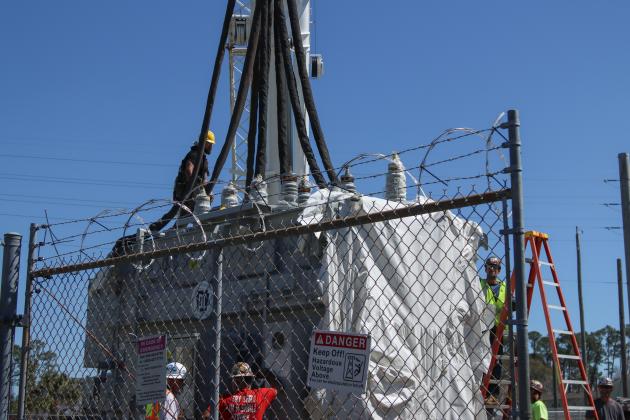 Electrical technicians and contractors work together to move a new transformer into the substation located at Lime and 10th streets. Photo by Ashley Chandler/News-Leader