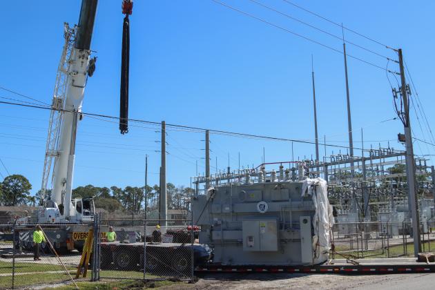Electrical technicians and contractors work together to move a new transformer into the substation located at Lime and 10th streets. Photo by Ashley Chandler/News-Leader