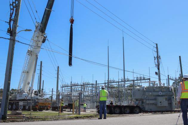 Electrical technicians and contractors work together to move a new transformer into the substation located at Lime and 10th streets. Photo by Ashley Chandler/News-Leader