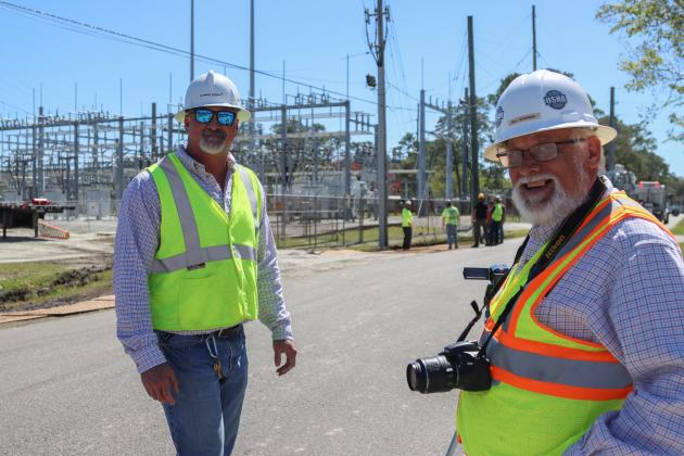 Brandon Jordan, substation technician with FPU, left, and Bill Edwards of Engineered Powered Products, work with other technicians and contractors to move a new transformer into the substation located at Lime and 10th streets. Photo by Ashley Chandler/News-Leader