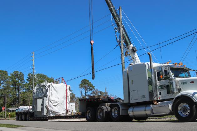 Electrical technicians and contractors work together to move a new transformer into the substation located at Lime and 10th streets. Photo by Ashley Chandler/News-Leader