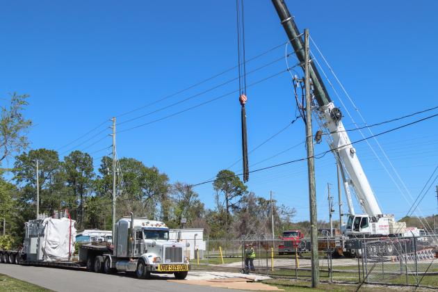 Electrical technicians and contractors work together to move a new transformer into the substation located at Lime and 10th streets. Photo by Ashley Chandler/News-Leader