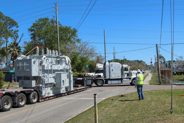 The driver of a double trailer truck maneuvers a 97,000-pound transformer around the corner of Lime and 10th streets to deliver to the substation. Photo by Ashley Chandler/News-Leader