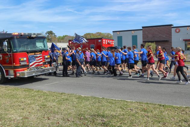Runners in the Law Enforcement Torch Run finish the final leg of the 1.26-mile run on Friday. Photos by Ashley Chandler/News-Leader