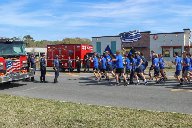 Runners in the Law Enforcement Torch Run finish the final leg of the 1.26-mile run on Friday. Photos by Ashley Chandler/News-Leader